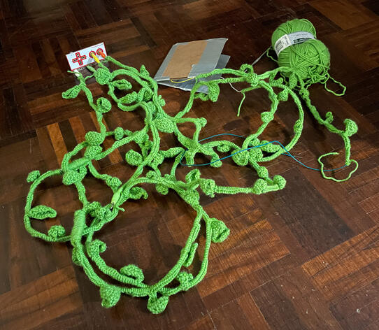 Crochet vine leaves to hide wiring that connects the axe, pedal, and stump.